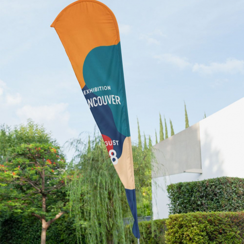 mockup-of-a-teardrop-flag-banner-placed-outside-a-building-28015